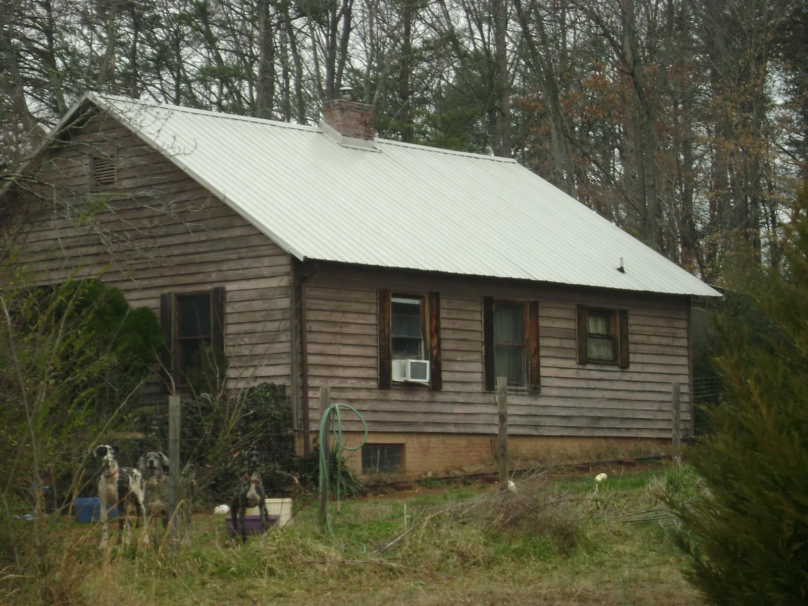 White metal roof on an old wood sided farmhouse, from a Metal Roof Installation job in Dakota City